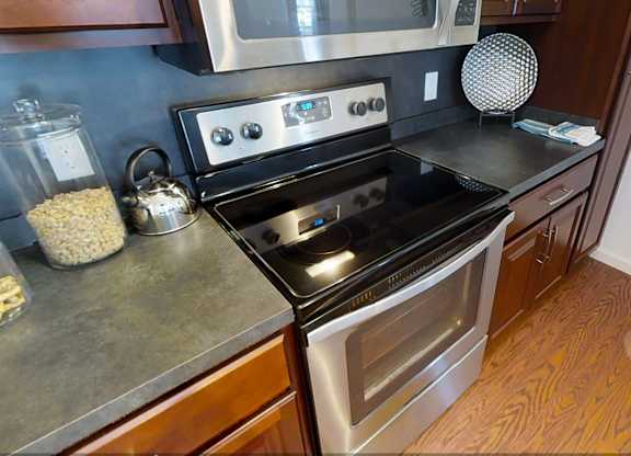 A modern kitchen with a black stove top oven at Meridian West Shore, Mechanicsburg Pennsylvania