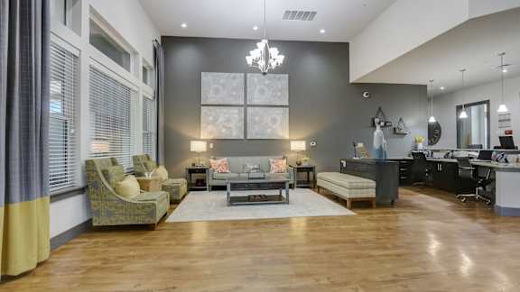 A modern living room with a grey sofa set and a wooden floor.
