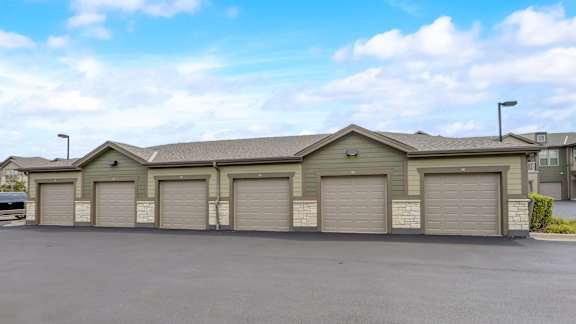A row of garage doors in front of a building.
