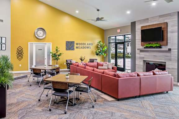 Living room with red couch at Woodland Meadows, Clinton Township