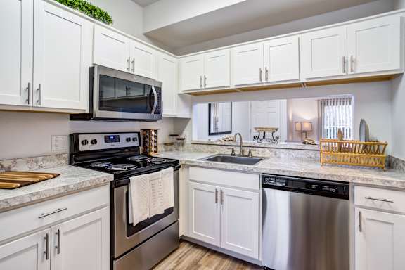 Kitchen with black oven at Woodland Meadows, Clinton Township, 48035