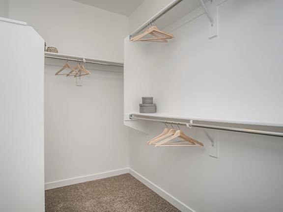 Walk-in closet with builtin storage shelving at Liberty Point Apartments, Draper, UT