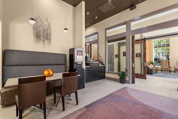 Lobby area with dining table and glass doorway at Liberty Gateway Apartments, Utah