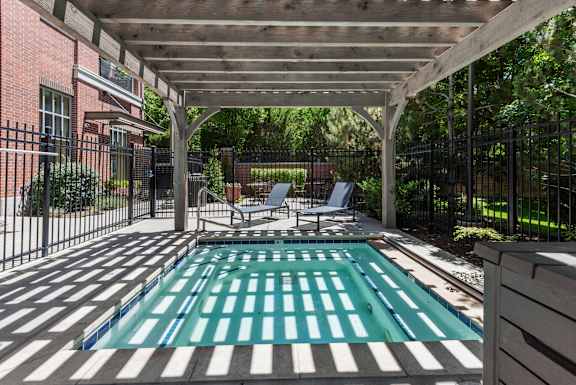 Swimming pool with pergola and surrounding fence at Liberty Gateway Apartments, Salt Lake City, UT