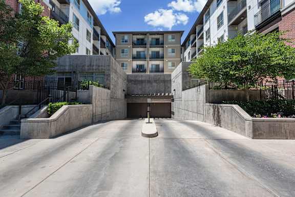 Underground parking garage entrance ramp with concrete walls at Liberty Gateway Apartments, Utah, 84101