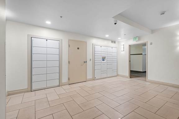 Mail locker room with parcel lockers and tiled flooring at Liberty Gateway Apartments, Salt Lake City, UT 84101