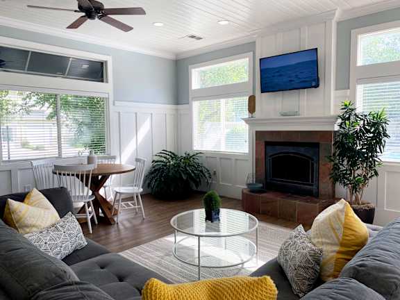 Open concept living room with fireplace and dining area at Liberty Hill Apartments, Draper, UT