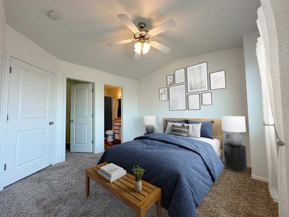 Bedroom with navy bedding and gallery wall at Liberty Hill Apartments, Draper, UT