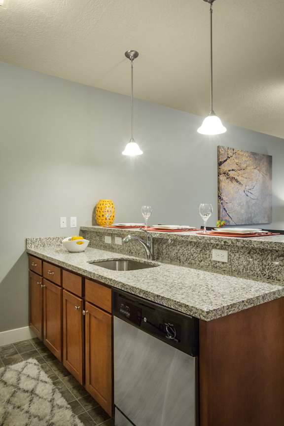 Liberty Gateway Apartments, Salt Lake City, UT, A kitchen with a granite counter top and a sink.
