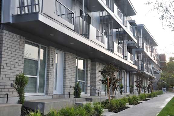 A modern apartment building with balconies and doors at Liberty Square Apartments - Saltlake City, UT Apartments, Saltlake City
