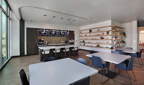 A modern dining area with a long table and chairs.