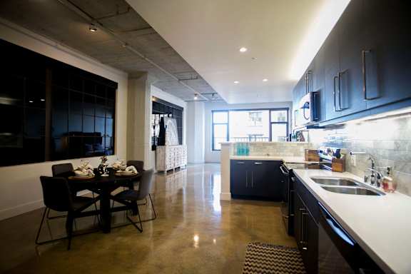 A modern kitchen with a dining table and chairs.