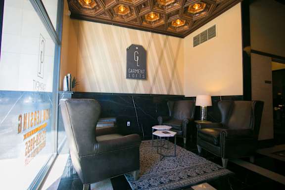 A living room with a couch, chair, and lamp.