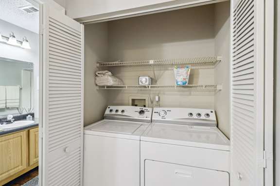 A white washer and dryer in a small laundry room.