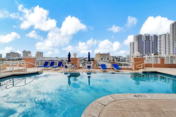 A large swimming pool with a view of the city skyline.