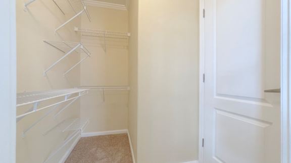 Empty white shelves in a room.