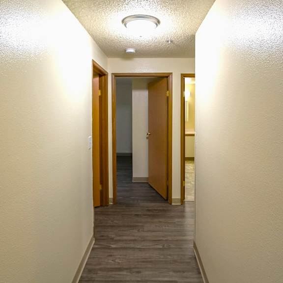 A long hallway with doors on both sides.