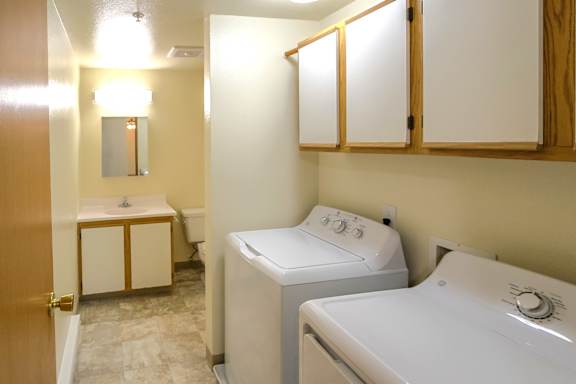 A small bathroom with a washer and dryer.