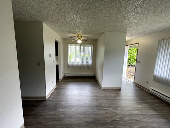 An empty dining alcove with a window and a door.