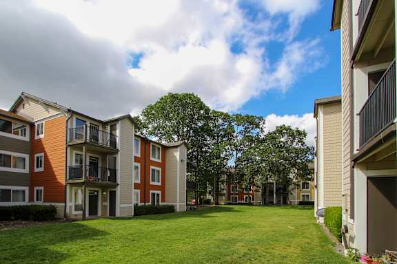 Apartment complex with a green lawn in front.