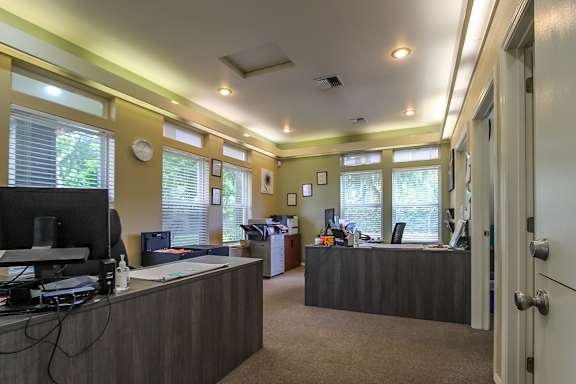 A room with a desk and a computer monitor.
