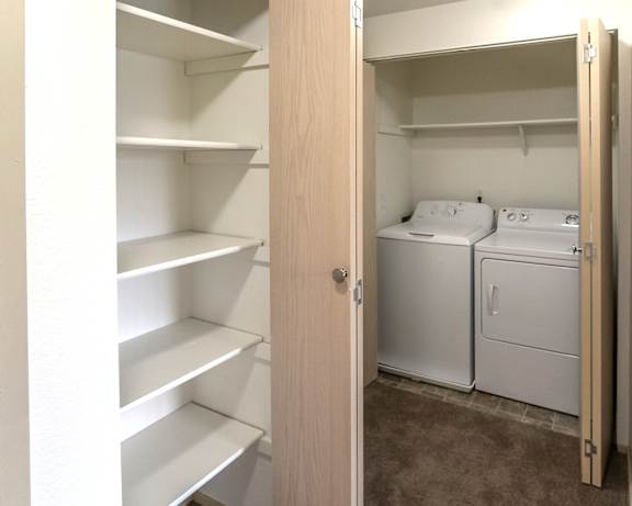 A small laundry room with a washer and dryer.