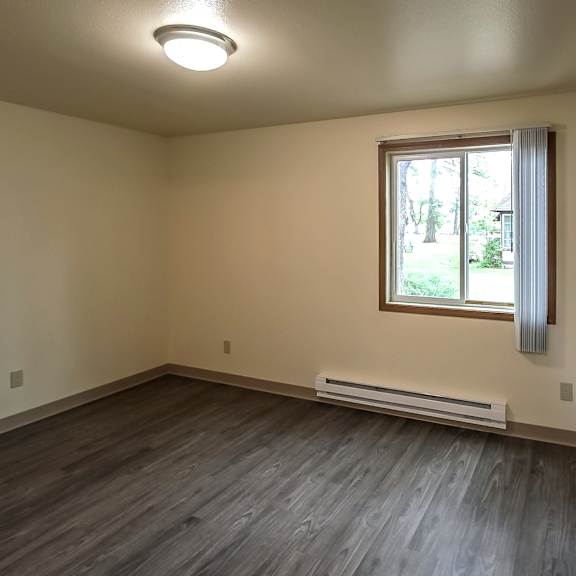 A room with a window and a wall-mounted light fixture.