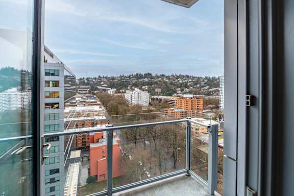 A view from a balcony looking out at a cityscape.