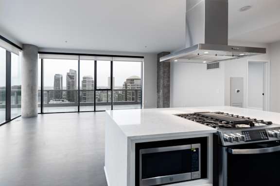 A modern kitchen with a stove top oven and microwave.