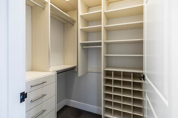 A white closet with drawers and shelves.