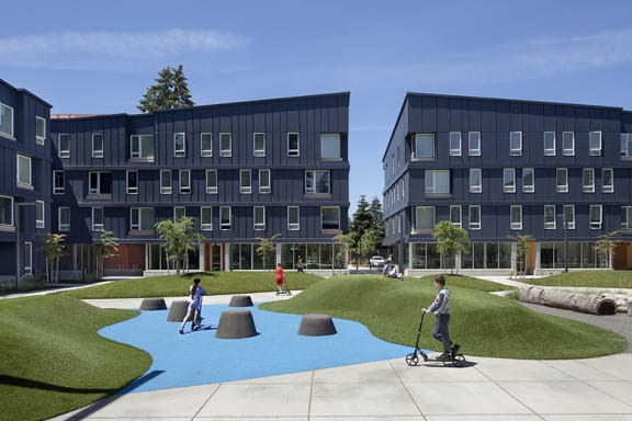 a rendering of a playground in front of an apartment complex