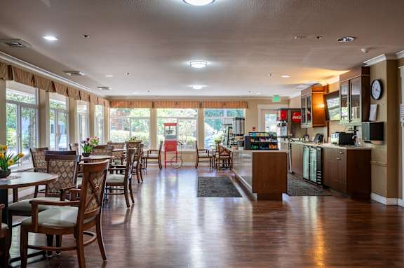 A restaurant with wooden floors and furniture.