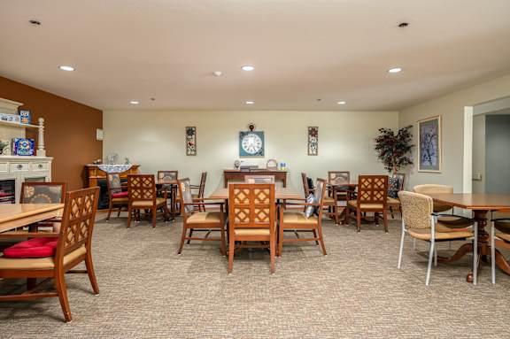 A room with wooden chairs and tables.