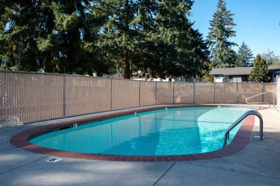 a resort style pool with a fence around it
