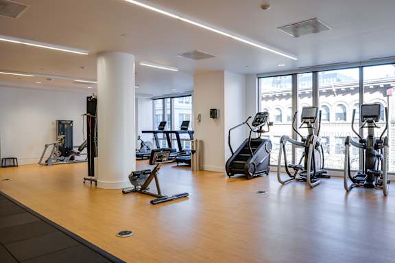 A gym with treadmills, elliptical machines and other cardio equipment.