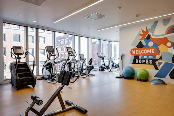 A gym with a sign that says "Welcome to the Ropes".