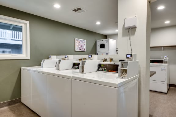 laundry room with washers and dryers and a window