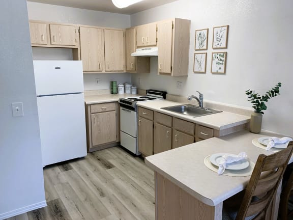 a kitchen with white appliances and wooden cabinets