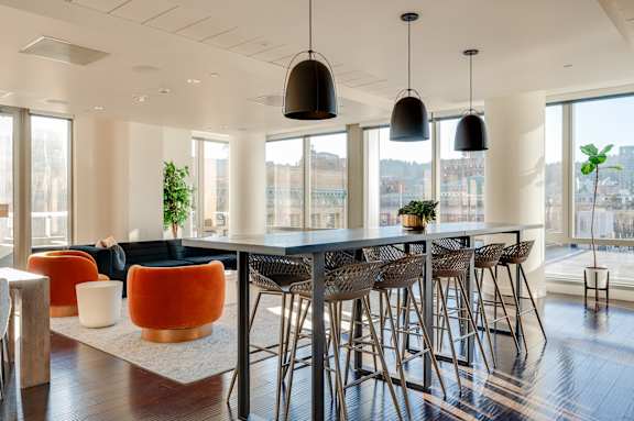 A modern dining room with a long table and chairs.