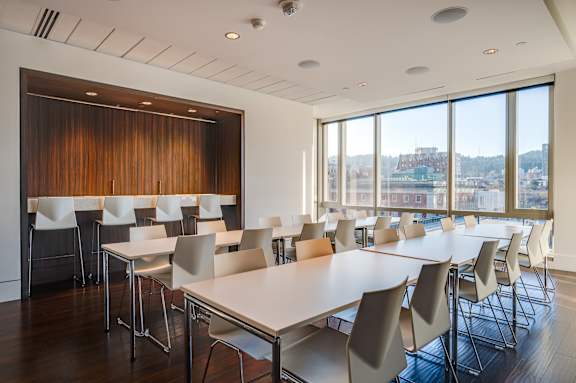 A conference room with a long table and chairs.