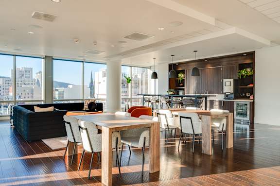 A modern dining room with a table set for four.
