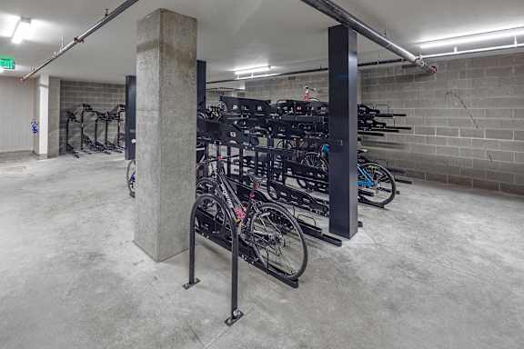 A bike rack with many bikes parked in a garage.