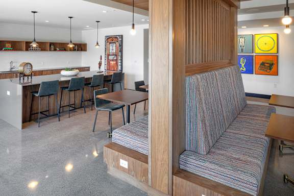 A living room with a couch and a dining table.