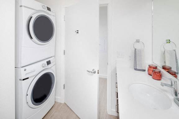 A white washing machine and dryer in a small laundry room.