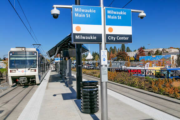 A train is on the tracks at the Milwaukie Main St station.