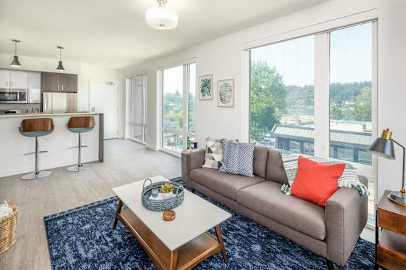 A living room with a grey couch and a coffee table.