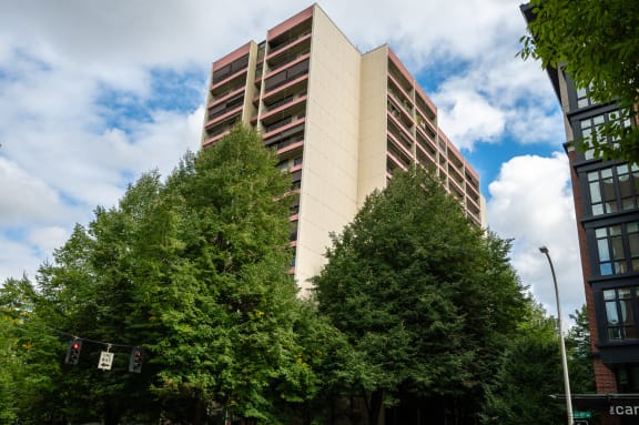 a tall building with trees in front of it
