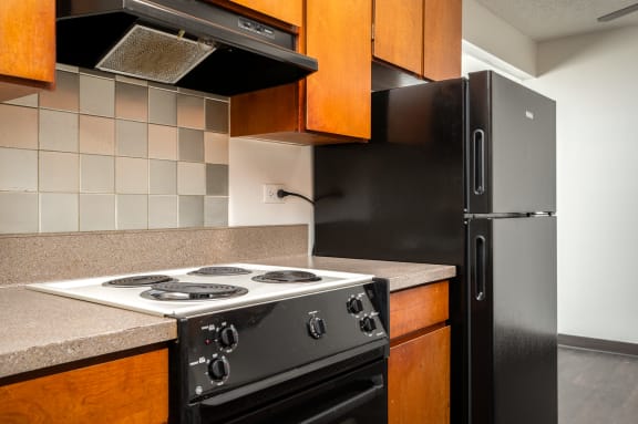 a kitchen with a stove and a refrigerator