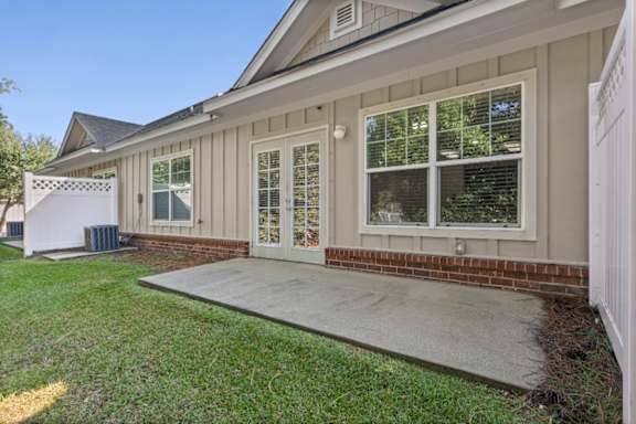 A house with a white fence and a covered patio.