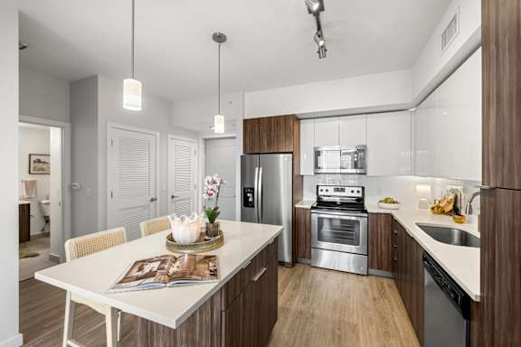 A modern kitchen with a dining table and chairs.